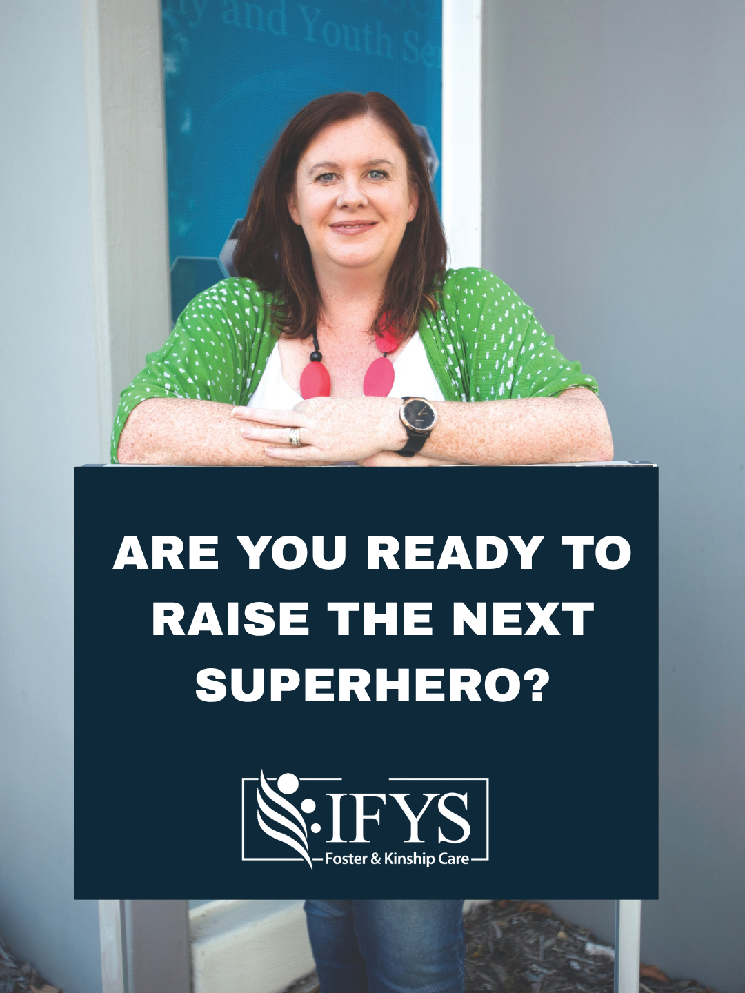 Shannon Davis holding a sign that reads: Are you ready to raise the next superhero?