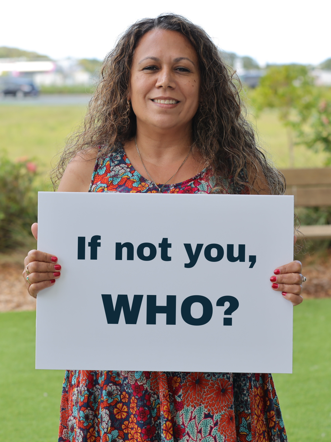 Tanya Frazer holding a sign that reads: If not you, who?
